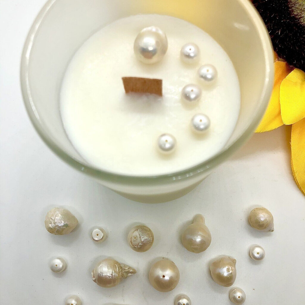 pearls in and beside candle