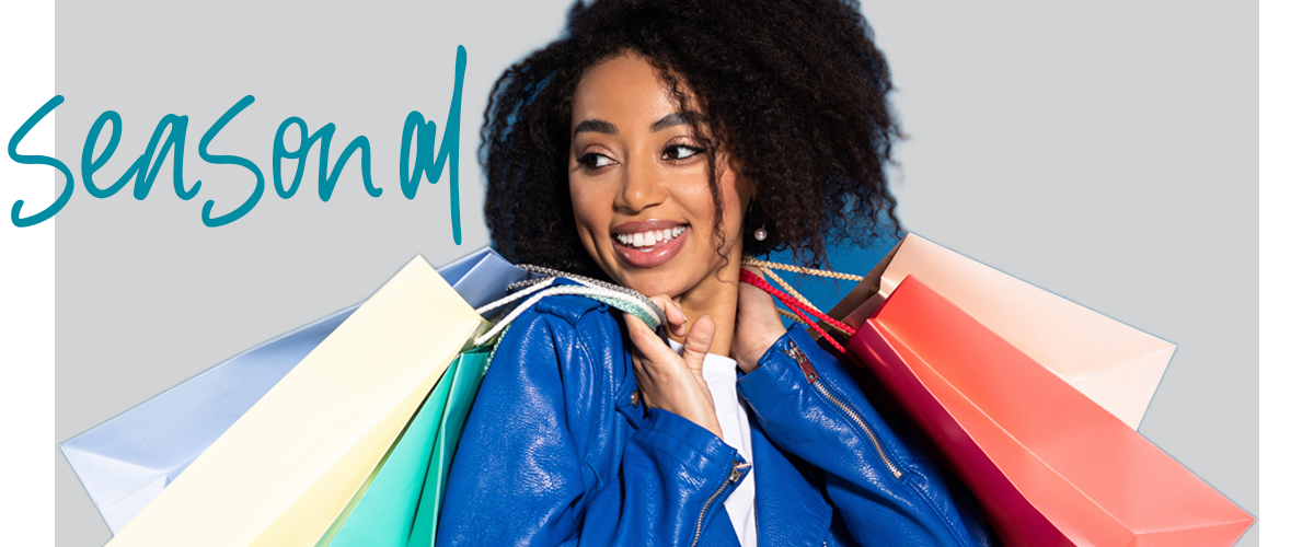 smiling black woman with shopping bags
