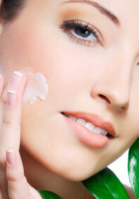 Woman applying image moisturizer cream